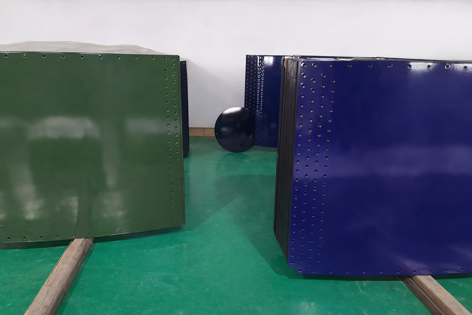 Green and blue glass-fused-to-steel panels on factory saddles